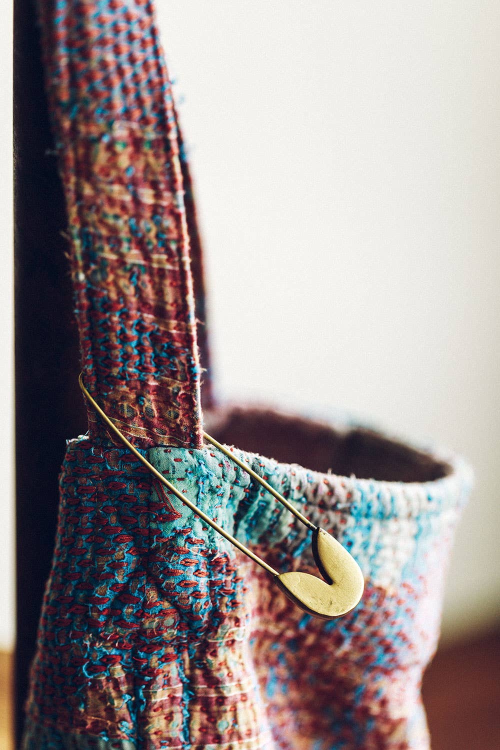 Fog Linen Work brass safety pin fastened on a knit