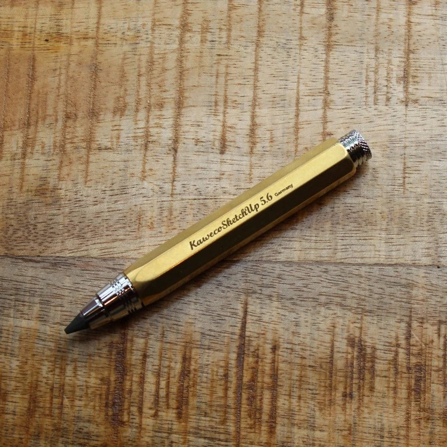 Kaweco brass pencil on a wooden table top