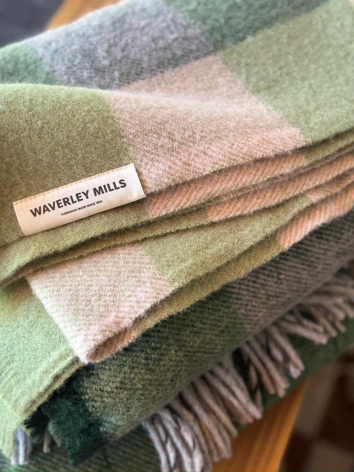Folded green and beige checkered blanket with Waverley Mills label