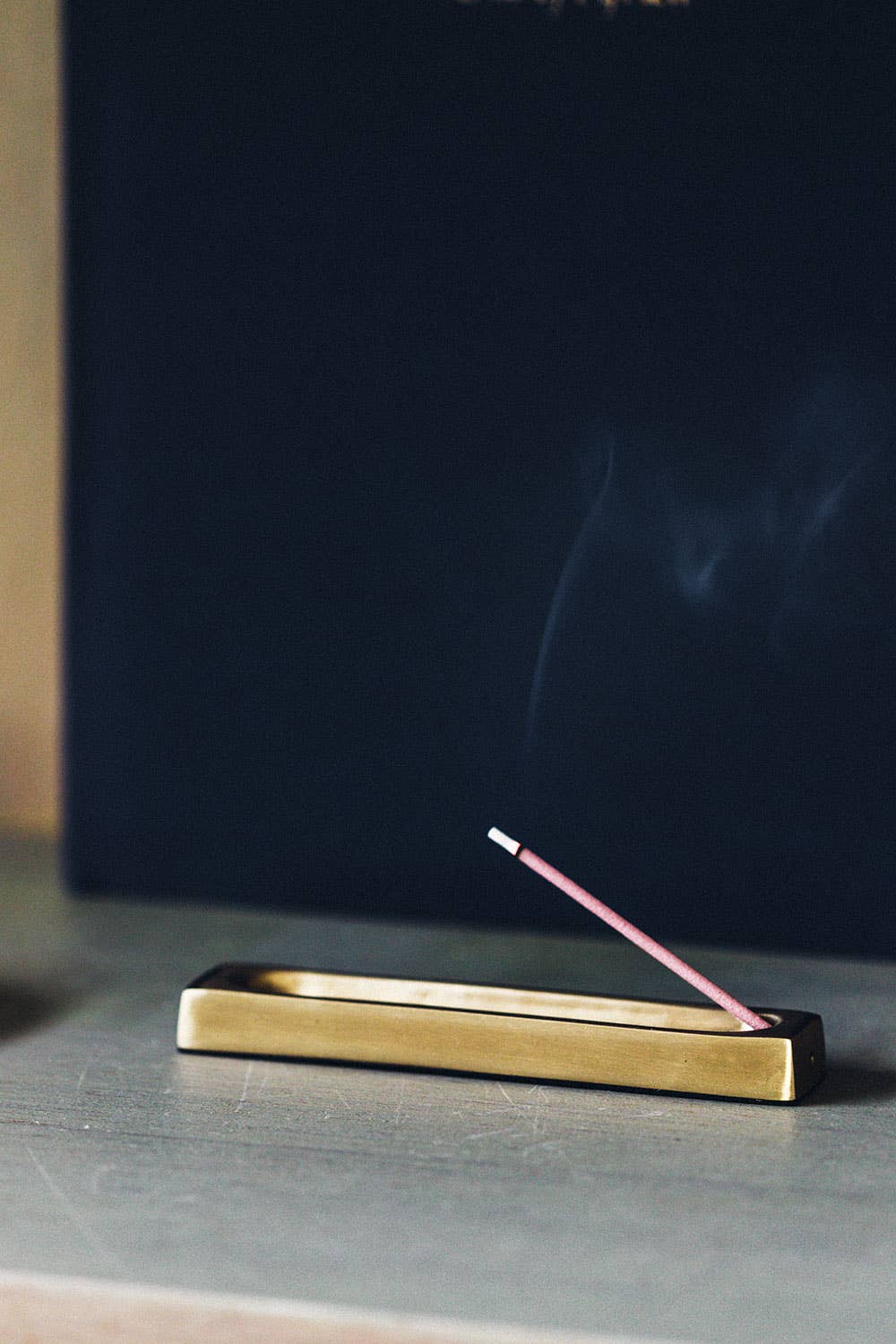 Fog Linen Work brass incense stand holding a stick of incense