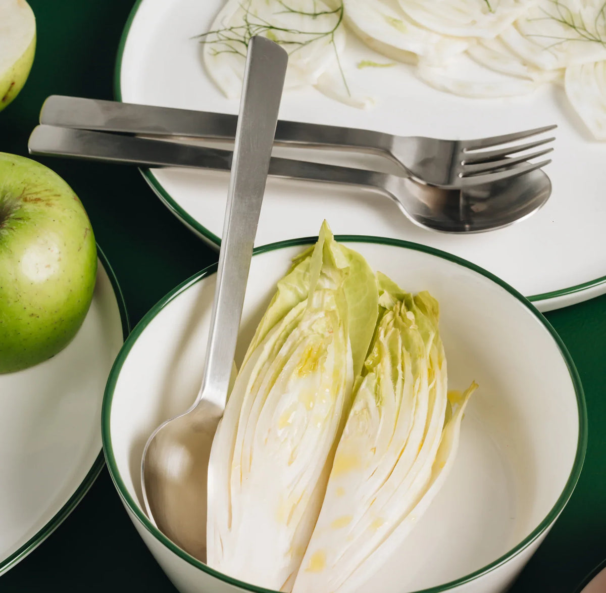 ACME round table spoon in brushed stainless steel, showing the round bowl